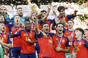Spain players celebrate with the title