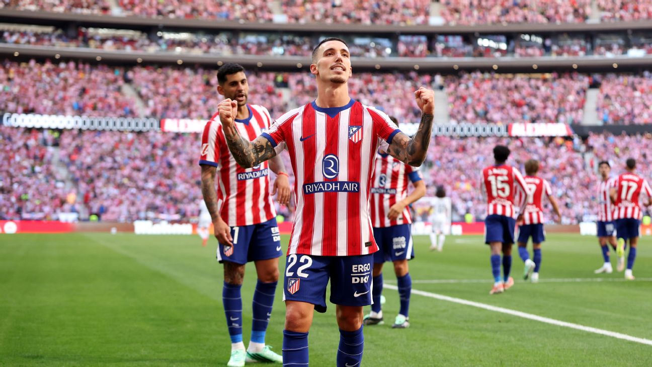 Atletico Madrid players celebrate after scoring against Real Madrid