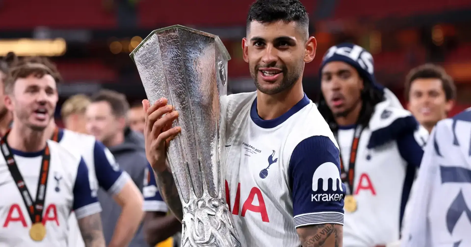 Cristian Romero holding a trophy.